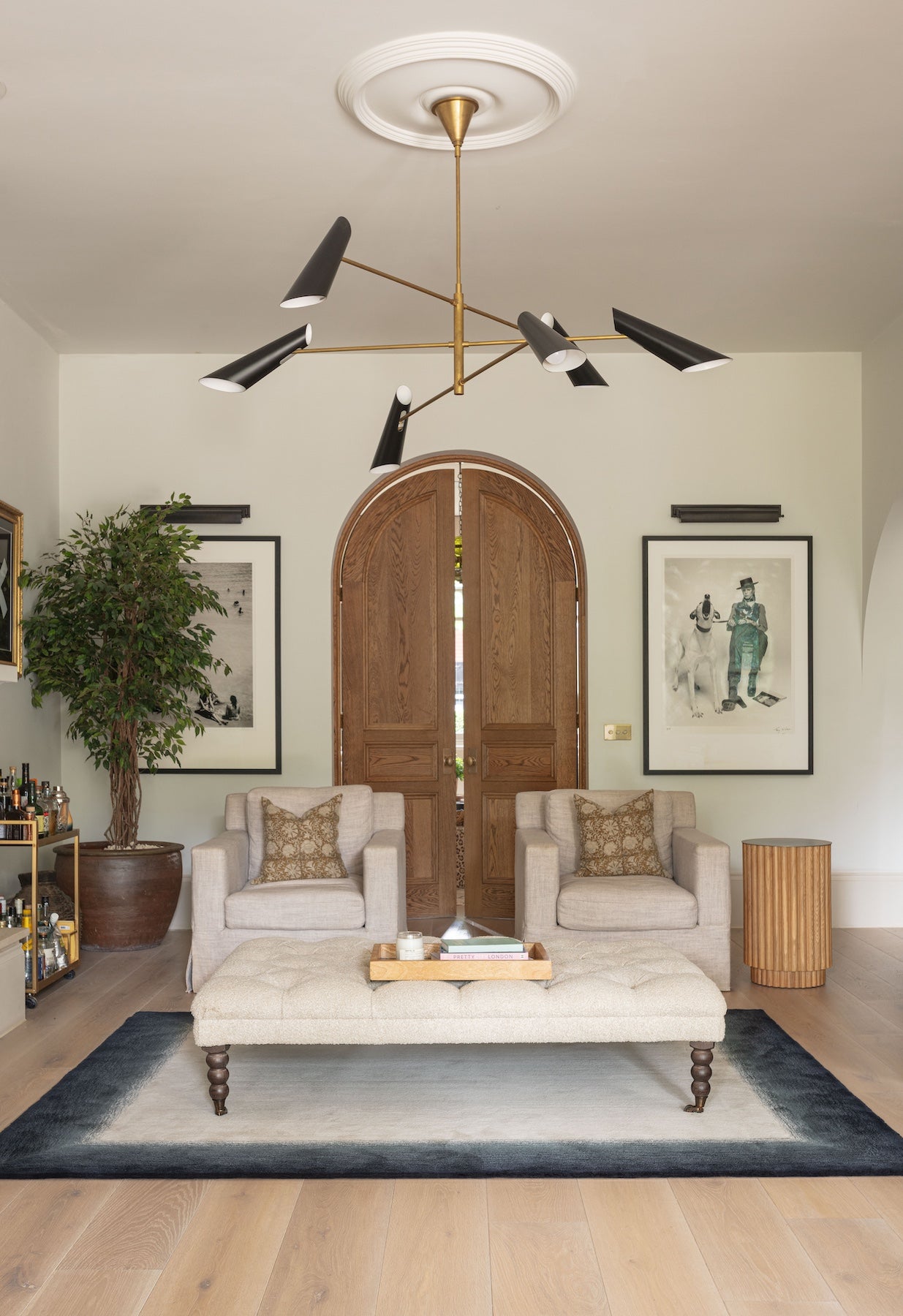 Bespoke rug in living room under ottoman. Border design with stipple graduation.