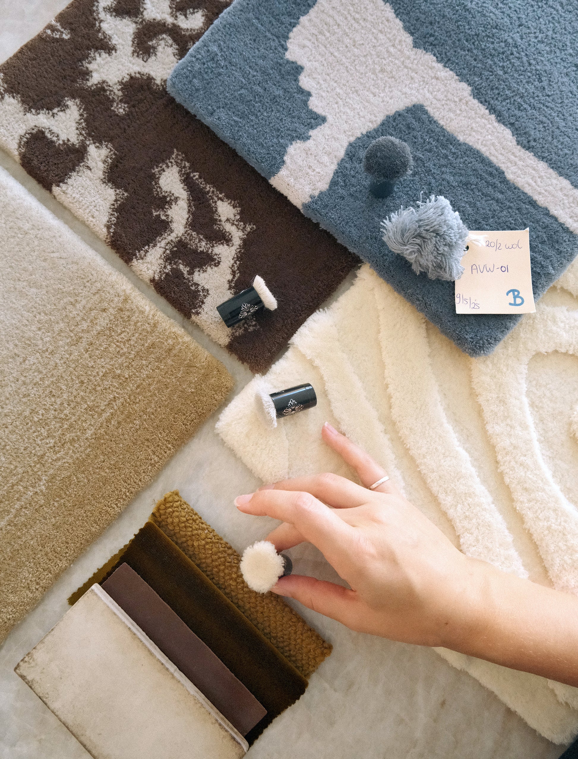 Using custom colour poms with carpet samples from the ethereal collection to scheme for an interior design project. Mood board flatlay style.